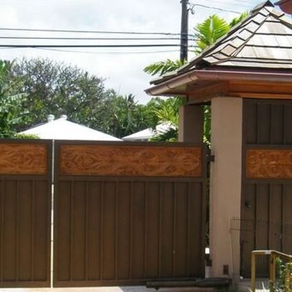 Timber entry gates set between stone piers, Kahala Residence, Oahu