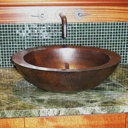 Hammered copper vessel sink set into a stone counter, North Shore Beach House, Oahu