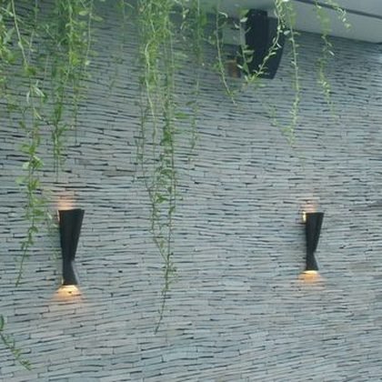 Stacked stone wall with wall mounted uplights, Toraja Villa, Bali