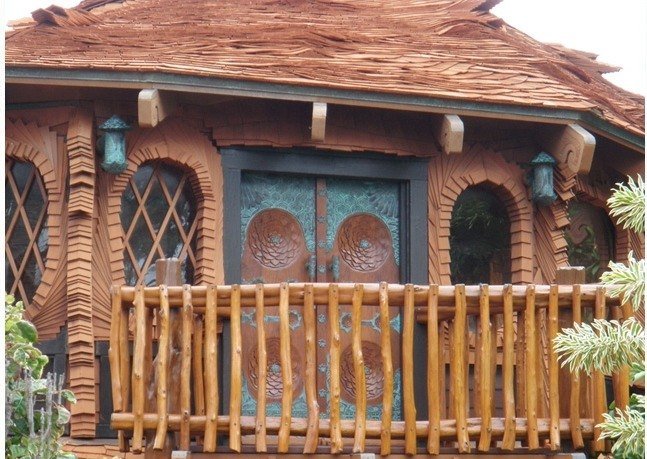 Carved timber lanai with painted doors and turned posts, Hale Krishna, Waimanalo