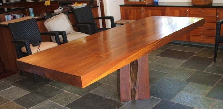 Live edge timber dining table on a slate floor, Portlock Residence, Oahu
