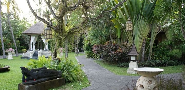 Garden path with carved stone figures and a pavilion, Puri Santrian, Sanur, Bali
