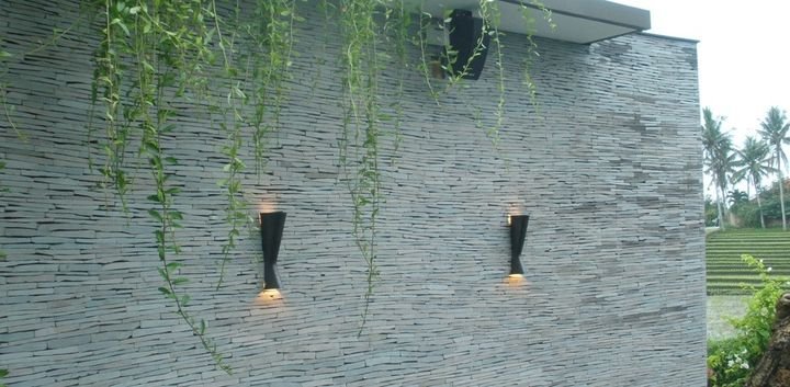 Stacked stone wall with wall mounted uplights, Toraja Villa, Bali