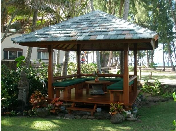 Thatched pavilion with a built in bench beside the lawn, Waimanalo Beach House, Oahu